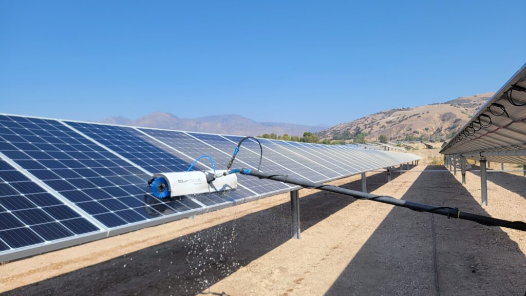 solar panel cleaning on a commercial solar installation in the southern california desert