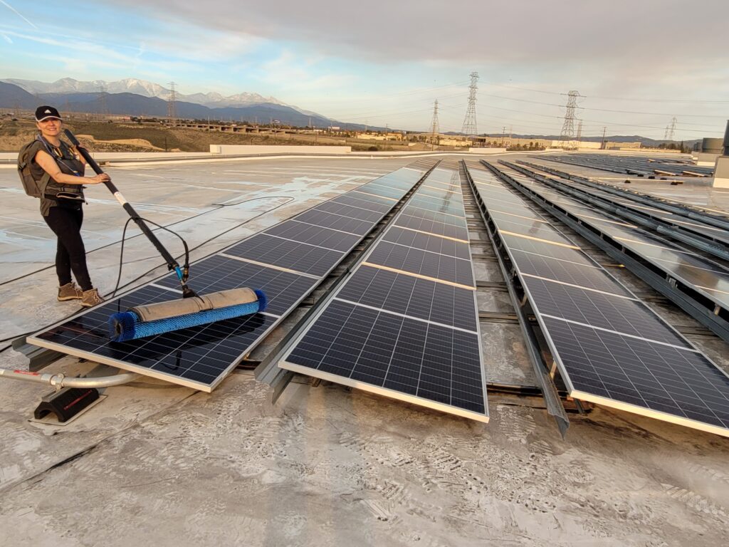 SoCal Solar Panel Cleaning Company cleaning a commercial installation with a solar brush