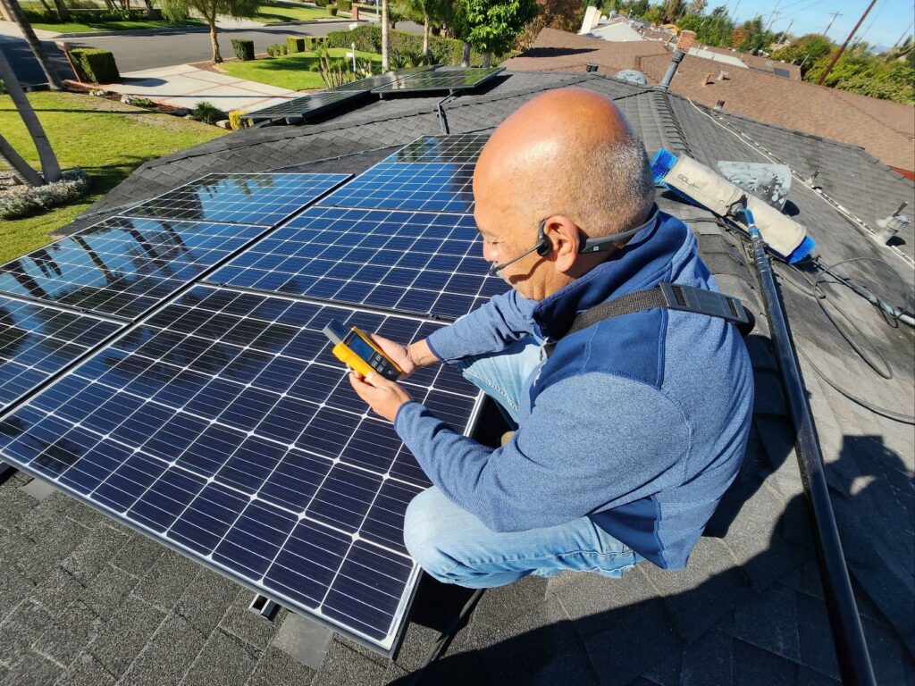 Henry Sanchez Conducting a solar panel efficiency check on a residential rooftop